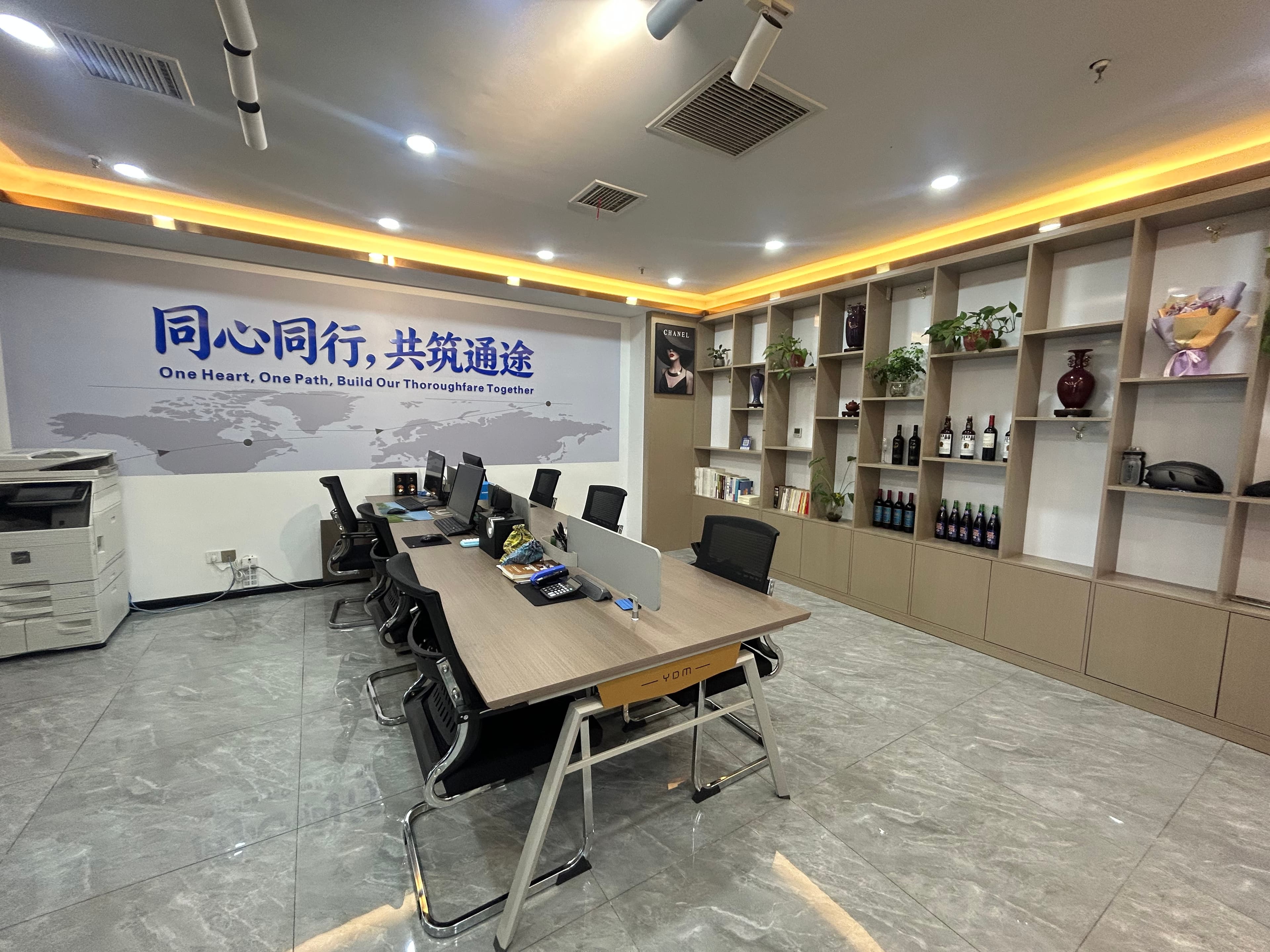 TONG TU office space with a world-map wall graphic and workstations